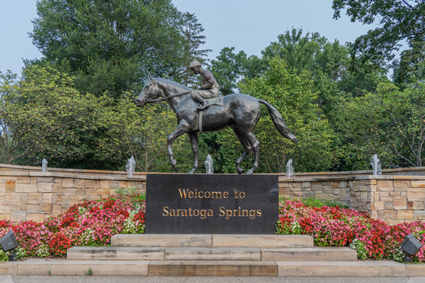 A jockey on a horse welcoming to Saratoga Spring NY